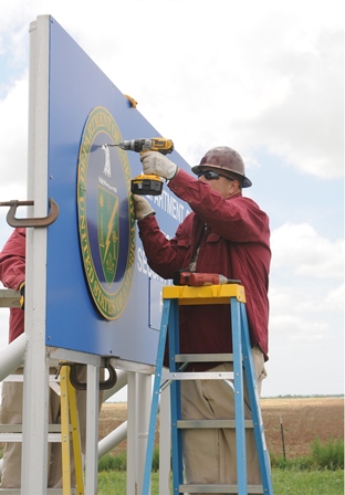 Workers put up a new entry sign at the Pantex Workers put up a new entry sign at the Pantex