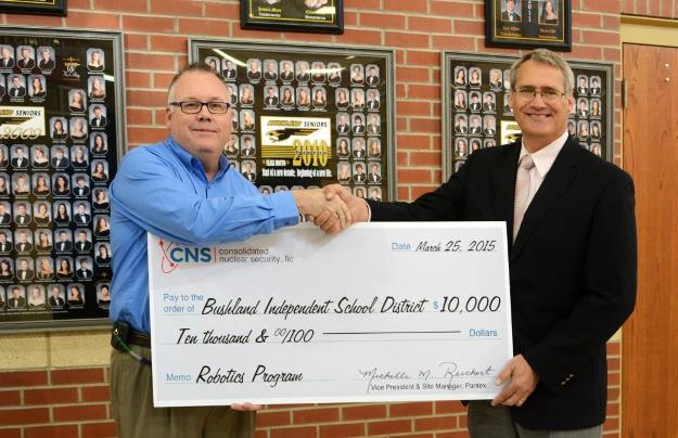 Joe Papp, CNS Director of Mission Engineering, presents the 0,000 donation to Don Wood, Bushland ISD Superintendent, to kick off the district's robotics program. Joe Papp, CNS Director of Mission Engineering, presents the 0,000 donation to Don Wood, Bushland ISD Superintendent, to kick off the district's robotics program.