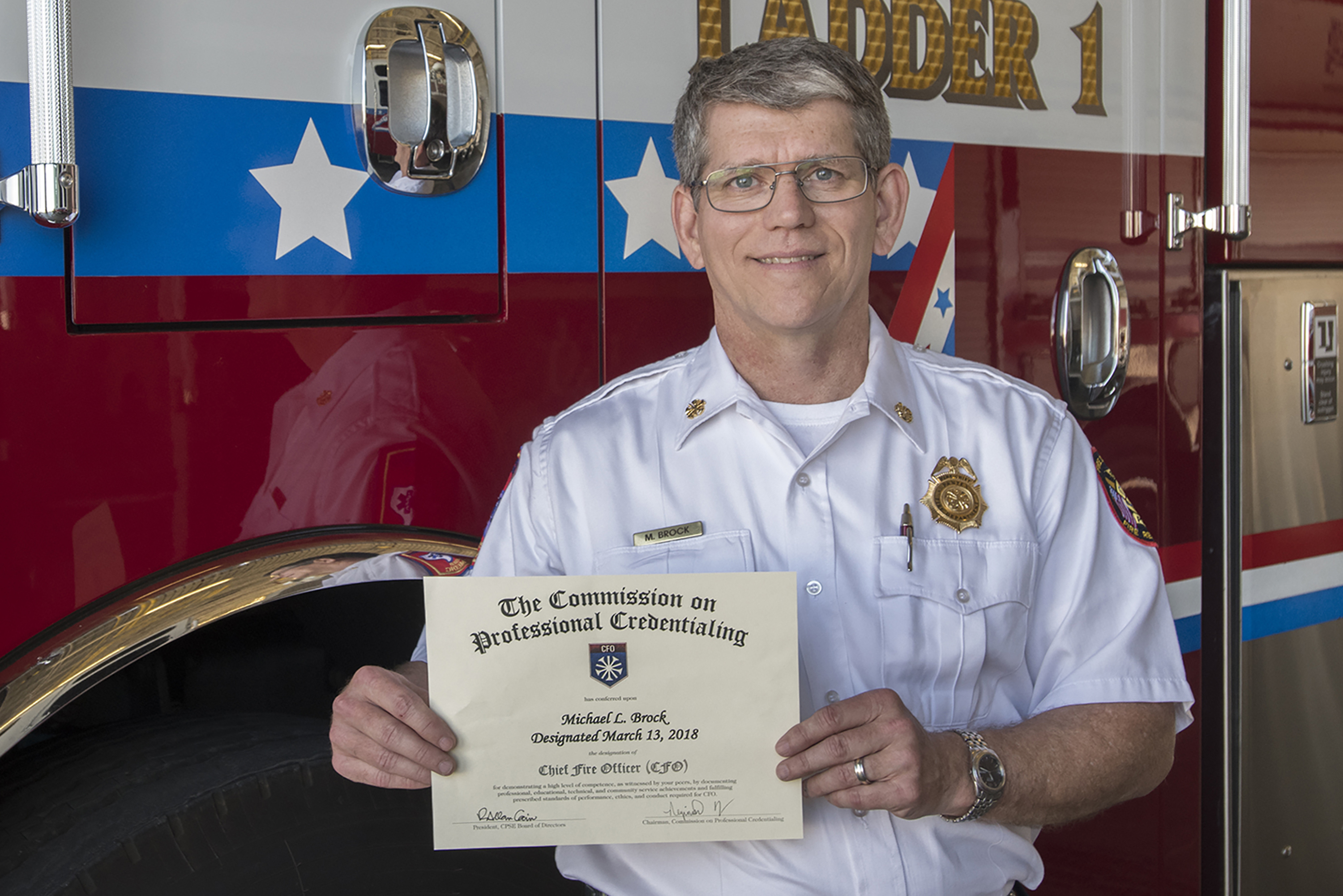 Chief Mike Brock displays his Chief Fire Officer Credentials Chief Mike Brock displays his Chief Fire Officer Credentials