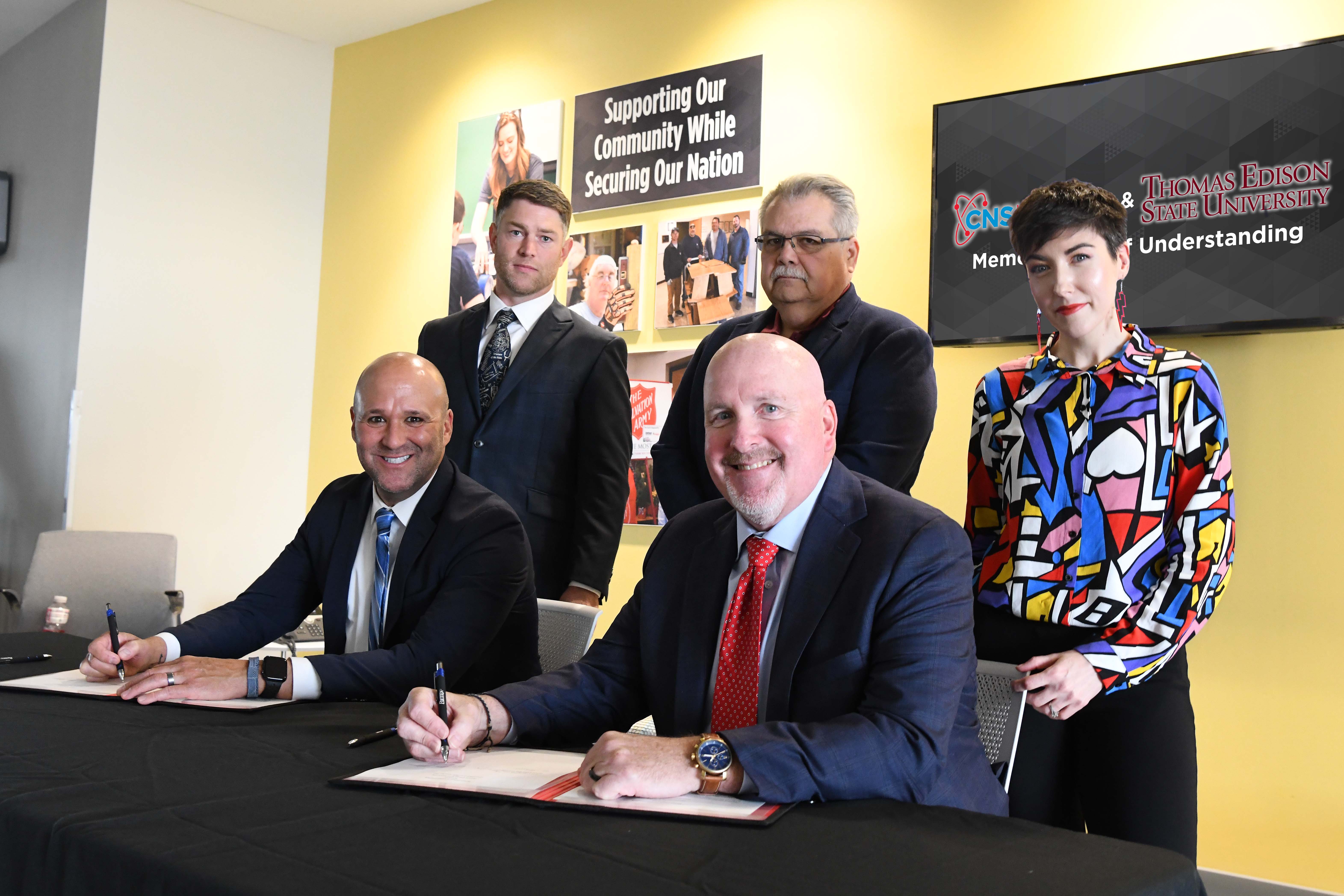 TEMU Thomas Phillips (front row, from left) and Pantex Deputy Site Manager Kenny Steward sign a memorandum of understanding TEMU Thomas Phillips (front row, from left) and Pantex Deputy Site Manager Kenny Steward sign a memorandum of understanding