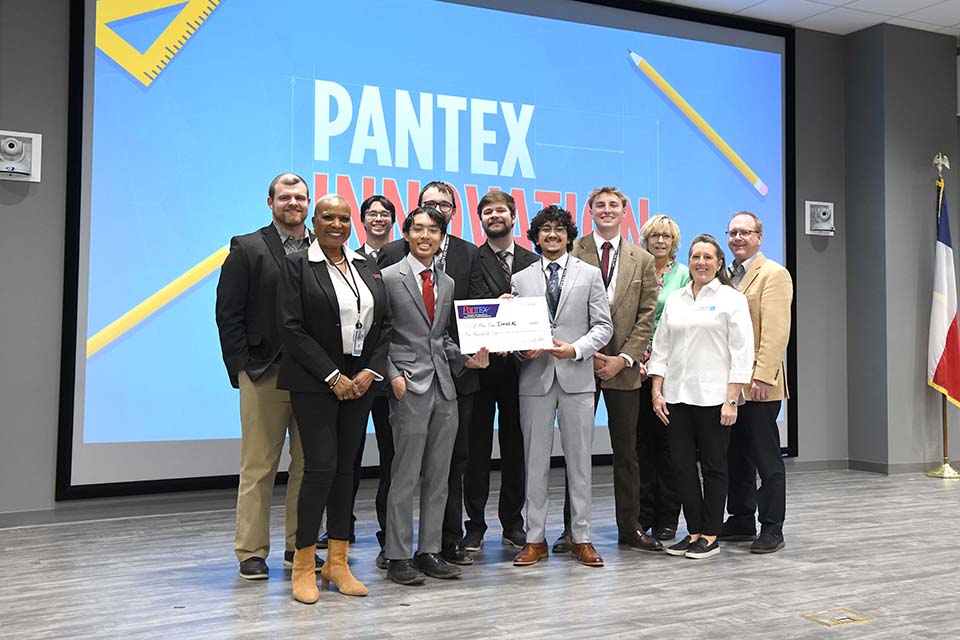 Students from the second-place team with the competition's judges and hosts. 