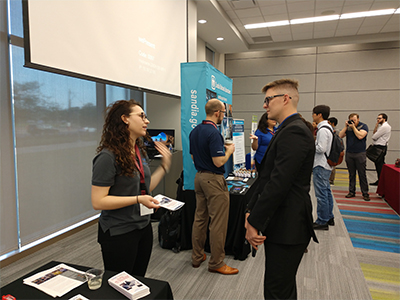 Alexi McCallick of Tooling and Tester Design at Pantex (left) talks with a student at the Texas A&M Nuclear Security Enterprise Day Alexi McCallick of Tooling and Tester Design at Pantex (left) talks with a student at the Texas A&M Nuclear Security Enterprise Day