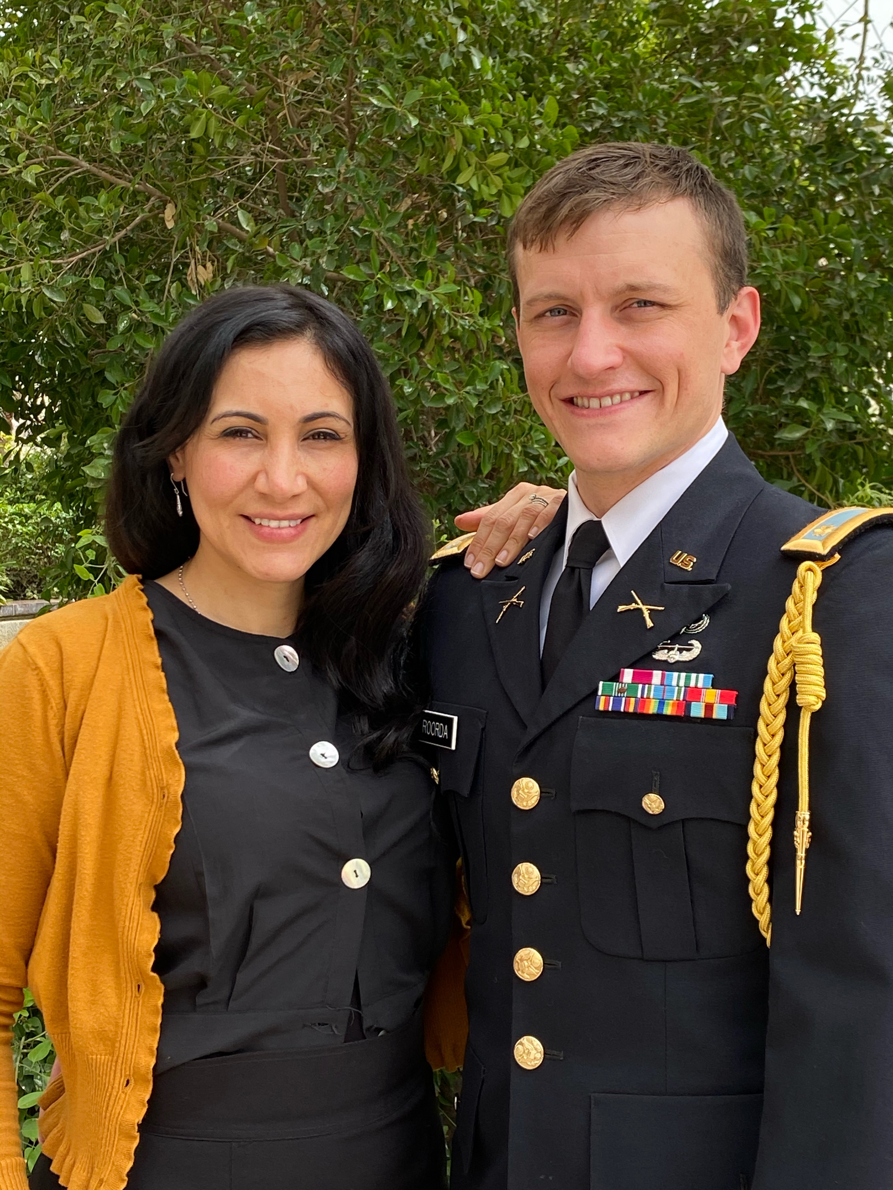 Rose R. stands with her husband, Major Brennan R., at his promotion ceremony. Rose R. stands with her husband, Major Brennan R., at his promotion ceremony.