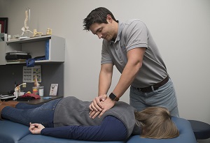 Pantex physical therapist Cody McClary applies pressure to a patient’s back to help alleviate discomfort. Pantex physical therapist Cody McClary applies pressure to a patient’s back to help alleviate discomfort.